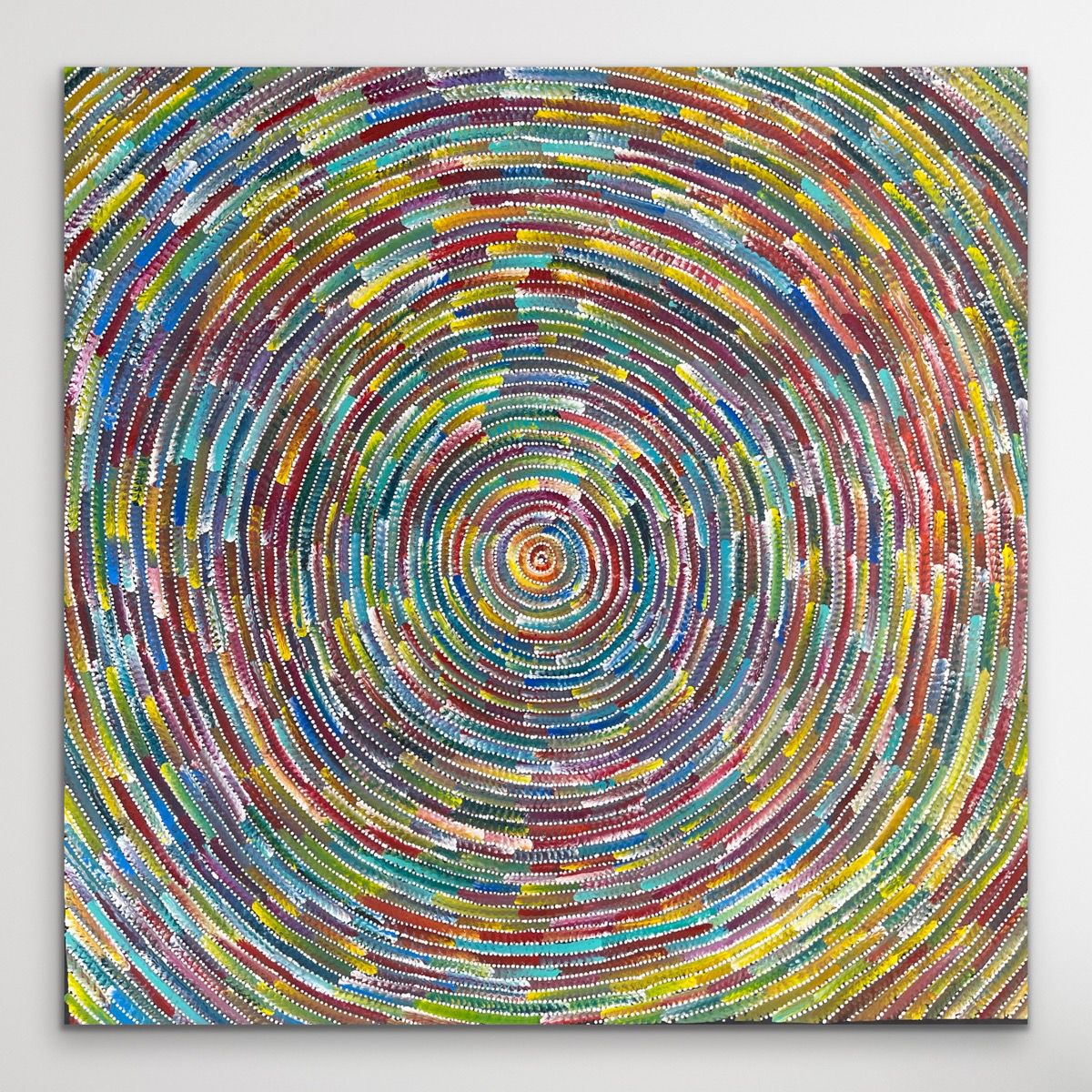 Colorful circular contemporary Aboriginal painting on a gray background