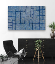 Load image into Gallery viewer, Blue abstract patterned wall art in a modern room with a black chair and wooden stool.

