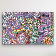 Load image into Gallery viewer, Full image of Pilitati Tjukurpa by Rhoda Tjitayi, featuring circular motifs and vibrant pink, green and purple tones.
