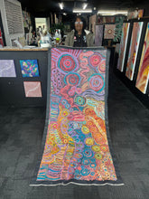 Load image into Gallery viewer, The artist Rhoda Tjitayi photographed holding her painting Pilitati Tjukurpa at Art by Farquhar Aboriginal Art Gallery.
