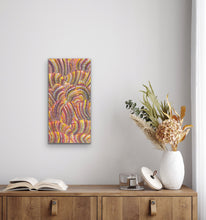 Load image into Gallery viewer, Colorful Indigenous painting on a wall above a wooden cabinet with decorative items.
