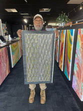 Load image into Gallery viewer, Marshall Jangala Robertson holding his Seed Dreaming Aboriginal artwork, 90cm x 44cm, authentic Indigenous painting captured with the artist.

