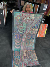 Load image into Gallery viewer, The piece glowing under natural light, showing its layered surface and tonal variation within a modern interior.
