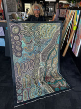 Load image into Gallery viewer, Teresa Pimangka holds Seven Sisters in our studio gallery, showing scale and luminous colour.
