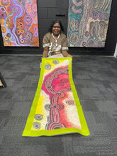 Load image into Gallery viewer, The artist Teresa Baker holding her Minyma Maililu painting inside Art by Farquhar Aboriginal Art Gallery, Adelaide.

