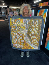 Load image into Gallery viewer, Teresa holding a her art with intricate patterns
