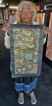 Load image into Gallery viewer, Teresa holding her Seven Sisters painting at Art by Farquhar gallery
