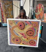 Load image into Gallery viewer, Audrey Brumby holding her painting "Tjukula"
