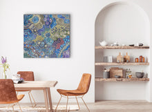 Load image into Gallery viewer, Dining room with a colorful Aboriginal art &quot;My Country (Utopia)&quot; Janet Golder Kngwarreye 94cm x 90cmpainting on the wall, wooden table, and chairs.
