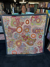 Load image into Gallery viewer, Julieanne Nungurrayi Turner holding the Women’s Ceremony painting in the gallery showing scale and overall composition.
