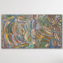 Load image into Gallery viewer, "Yam Dreaming" Jedda Purvis Kngwarreye 154cm x 87cm dots, lines, and curved stripes in a wide variety of colours including blue, green, yellow, pink, and orange, displayed on a neutral light gray wall.
