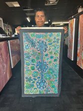 Load image into Gallery viewer, bernadine holding her artwork at art by farquhar gallery
