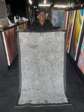 Load image into Gallery viewer, Bush Onion painting by Nancy Martin Napangarti 143cm x 87cm, artist holding large canvas with intricate dot work. artist photo
