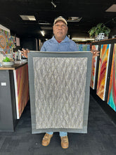 Load image into Gallery viewer, Marshall Jangala Robertson holding his black and white Seed Dreaming painting - Warlpiri artist from Yuendumu with monochrome artwork

