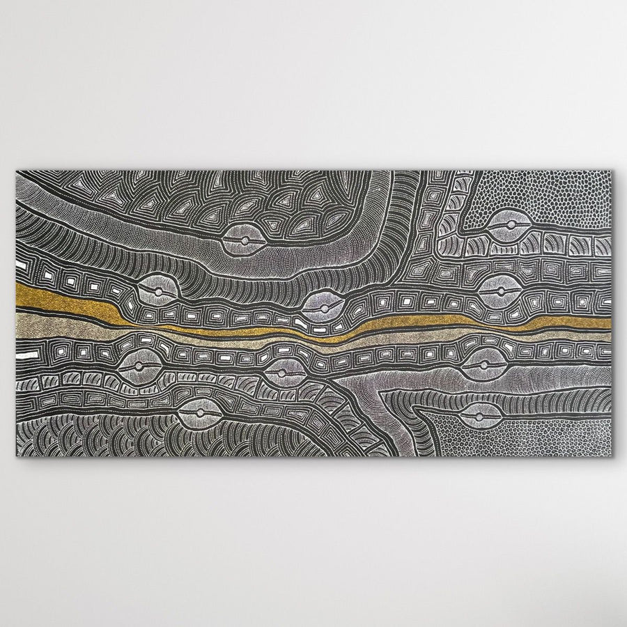 "My Country" by Delvine Pitjara, Aboriginal artwork from Utopia depicting her ancestral landscape through detailed patterns and flowing brushwork displayed on white wall