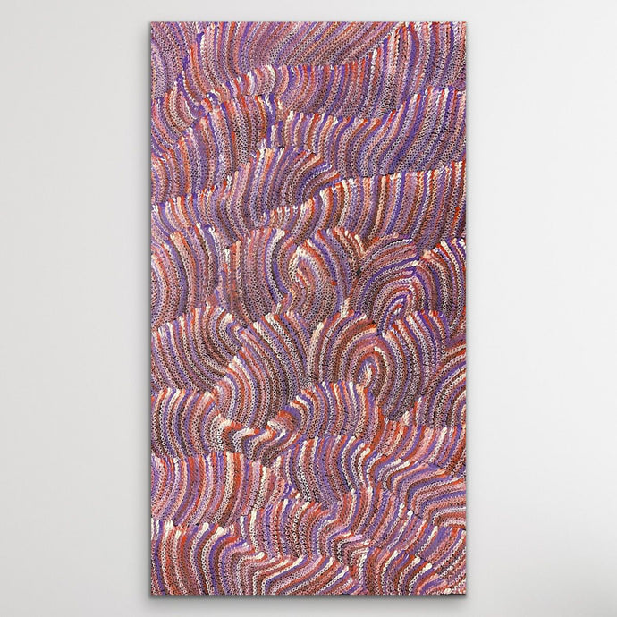 dot painting with wavy pattern in purple, orange, and pink displayed on wall