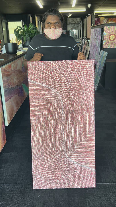 Tansy Martin holding her Bush Onion Painting