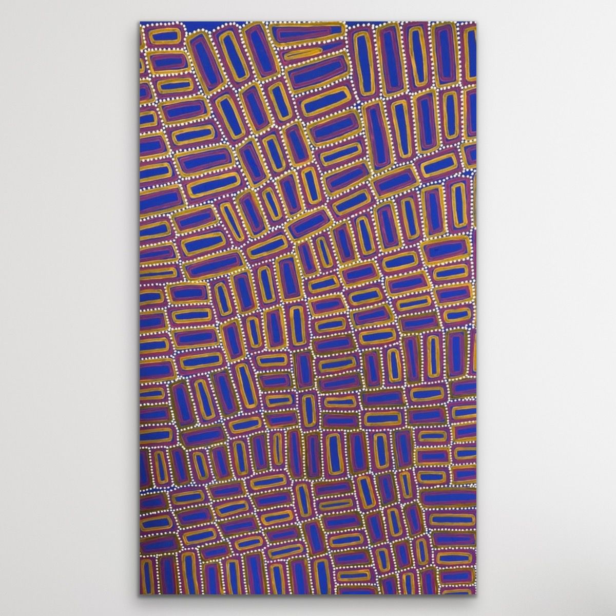 Tingari cultural Aboriginal story geoemtric shapes in yellow, red and vibrant ultramarine blue, with white dots