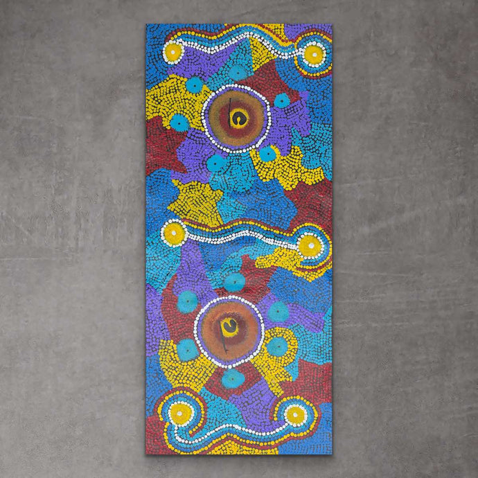 An original indigenous painting featuring geometric and natural elements in vibrant colors on a vertical canvas.